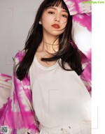 Haruna Kawaguchi 川口春奈, MAQUIA マキア Magazine 2022.05 A woman with long black hair wearing a white shirt and pink tie dye shirt.