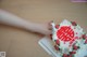 A person is holding a cake with a chinese symbol on it.