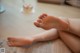 A baby's feet covered in cream sitting on the floor.