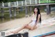A woman in a white bathing suit sitting on a boat.