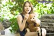 A woman sitting on a bench holding a teddy bear.